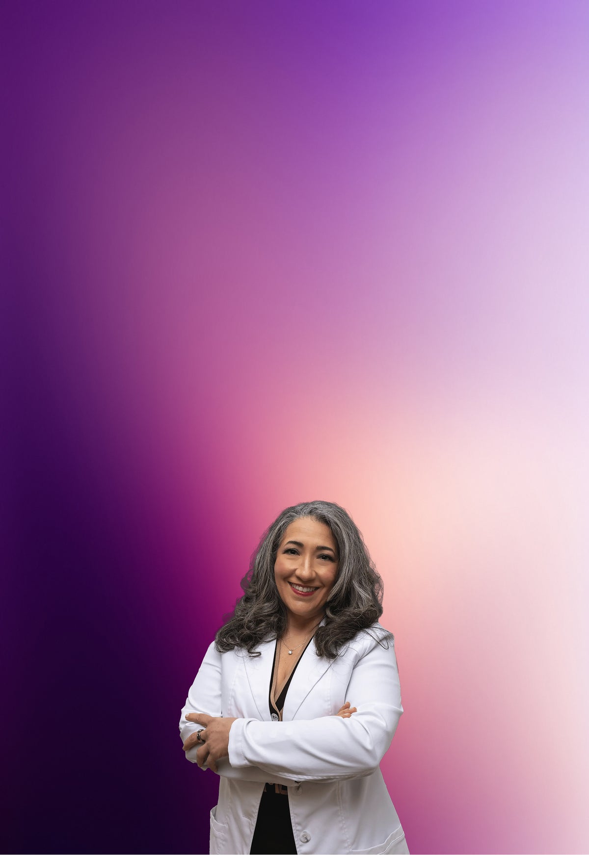 Dr. Andrea Matsumura wearing a white coat against a gradient purple and pink background